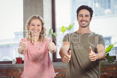 Business people giving thumbs up