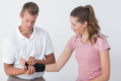 Doctor examining a man wrist