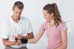 Doctor examining a man wrist