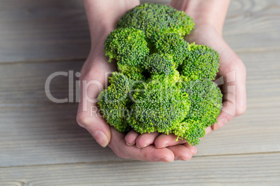 Woman showing fresh green brocolli