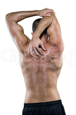 Shirtless athlete stretching elbow