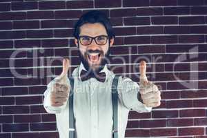 Portrait of happy man with thumbs up gesture