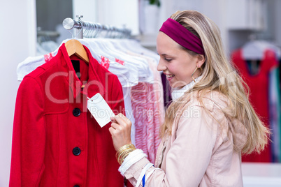 Smiling woman looking at price tag