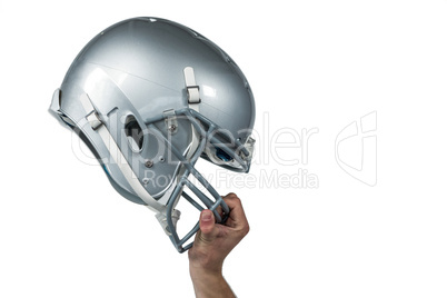 American football player handing his sliver helmet