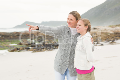 Mother and daughter looing towards the sea
