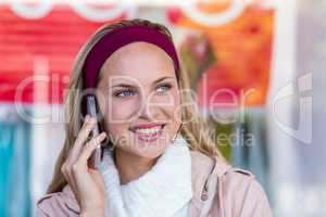 Smiling woman phoning with smartphone