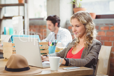 Young businesswoman working on laptop in office