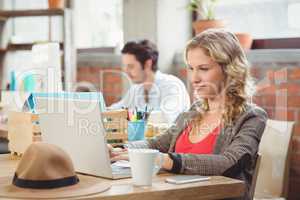 Young businesswoman working on laptop in office