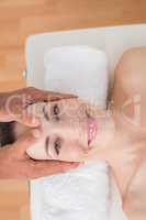 Smiling woman receiving head massage