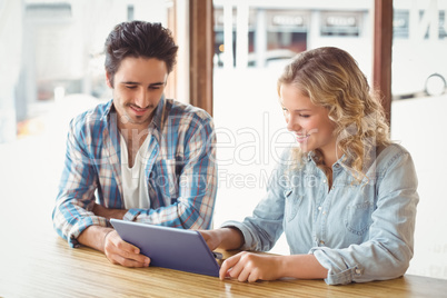 Business people looking at digital tablet in office