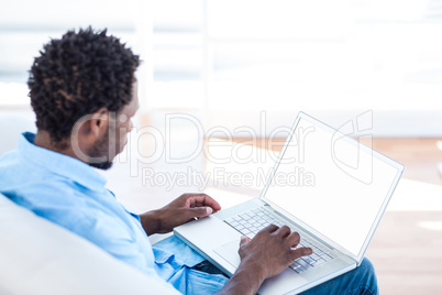 Young man working on laptop at home