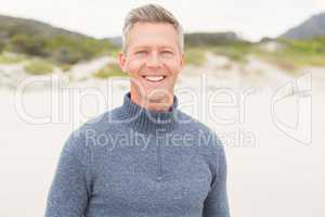 Smiling man standing at the beach