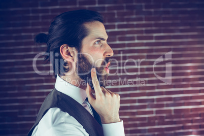 Side view of hipster with hand on chin thinking