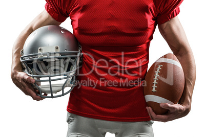 Midsection of American football player in red jersey holding hel