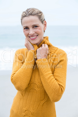 Smiling woman standing in front of the sea