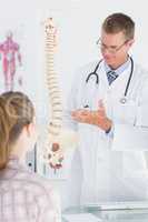 Doctor explaining anatomical spine to his patient