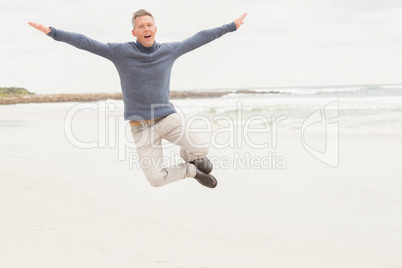 Man standing with arms out wide