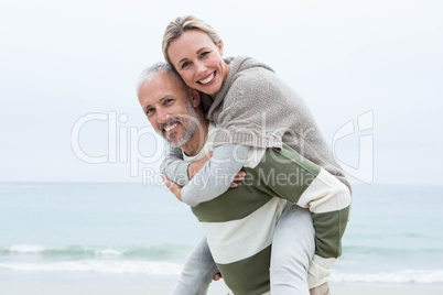 Man giving his partner a piggy back