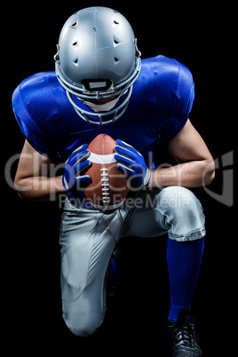 American football player kneeling