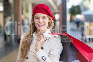 A smiling woman with shopping bags