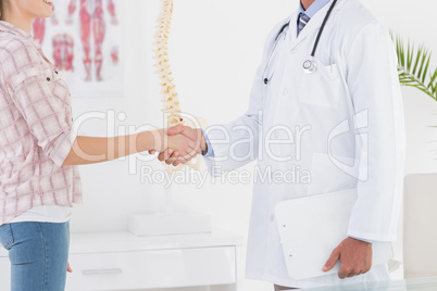 Patient shaking hands with doctor