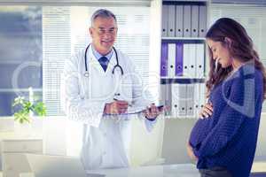 Pregnant woman with male doctor at hospital