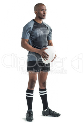 Confident athlete holding rugby ball