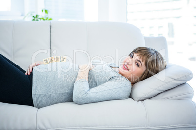 Portrait of pregnant woman playing with wooden blocks