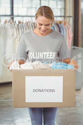 Woman holding clothes donation box