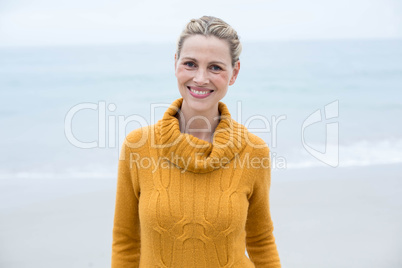 Smiling woman standing in front of the sea