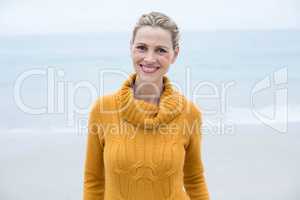 Smiling woman standing in front of the sea