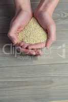 Woman showing handful of sesame seed