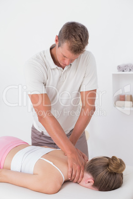 Physiotherapist doing neck massage to his patient