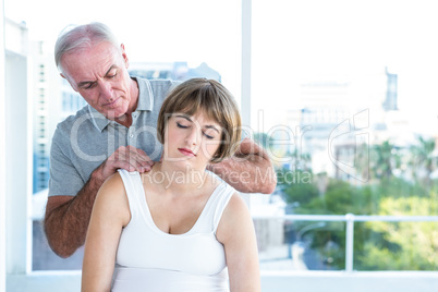 Therapist massaging pregnant woman