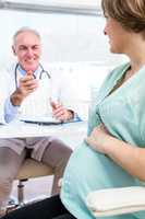 Pregnant woman with doctor in clinic