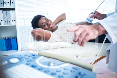 Doctor showing ultrasound results on monitor to woman