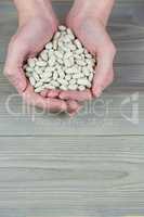 Woman showing handful of lima beans