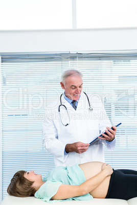 Doctor examining pregnant woman at clinic