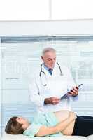 Doctor examining pregnant woman at clinic