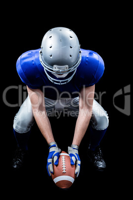 American football player placing ball