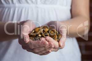 Woman showing handful of almonds