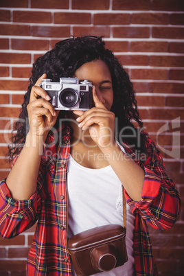 Hipster using a retro style camera