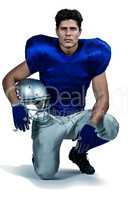 Portrait of confident American football player holding helmet