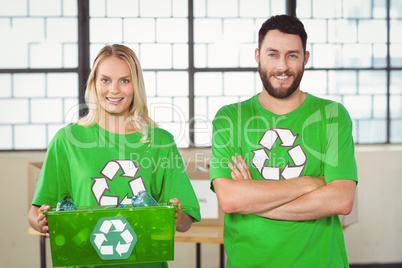 Portrait of woman holding container with man