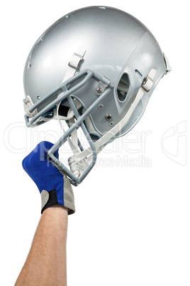 Cropped image of American football player handing his helmet