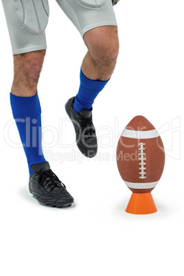 Low section of sports player being about to kick ball