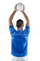 Rear view of sports player throwing ball
