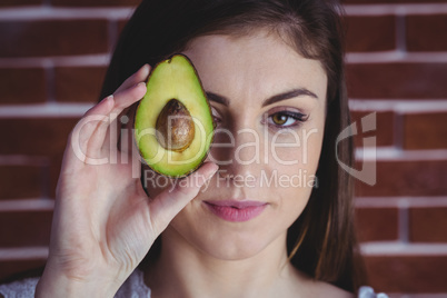 Woman showing fresh avocado