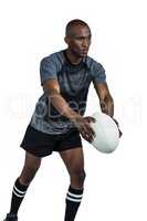 Rugby player in position of throwing ball