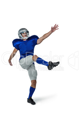 American football player kicking